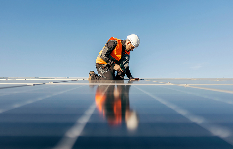 man working on solar panels